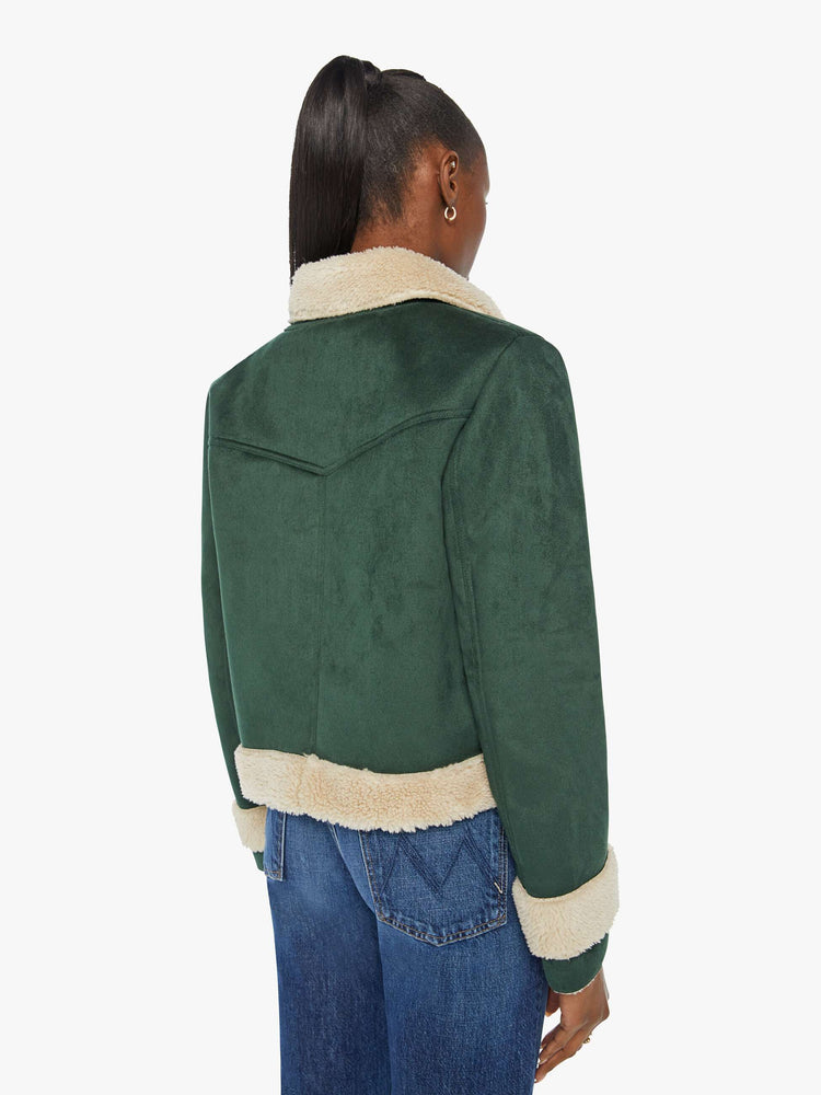 Back view of a woman in a dark green faux suede with cream faux sherpa collared zip-up jacket with a slightly cropped hem and a boxy fit.