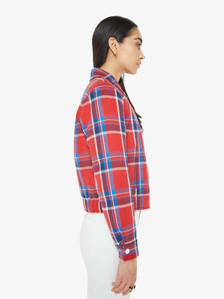 Side view of a woman in a retro inspired collard jacket with a cropped boxy fit buttons down the front and an elastic hem.