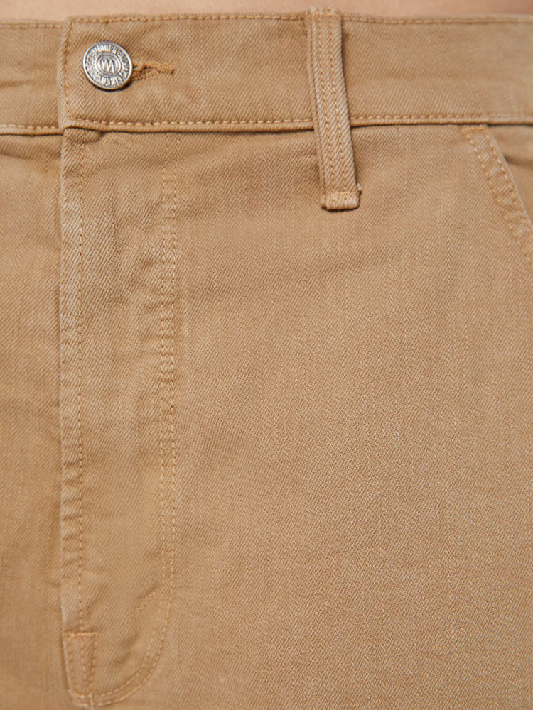 Detailed view of a woman in dark khaki high-waisted bermuda shorts designed to sit lower on the hips with a long 9.5-inch inseam and a frayed hem.