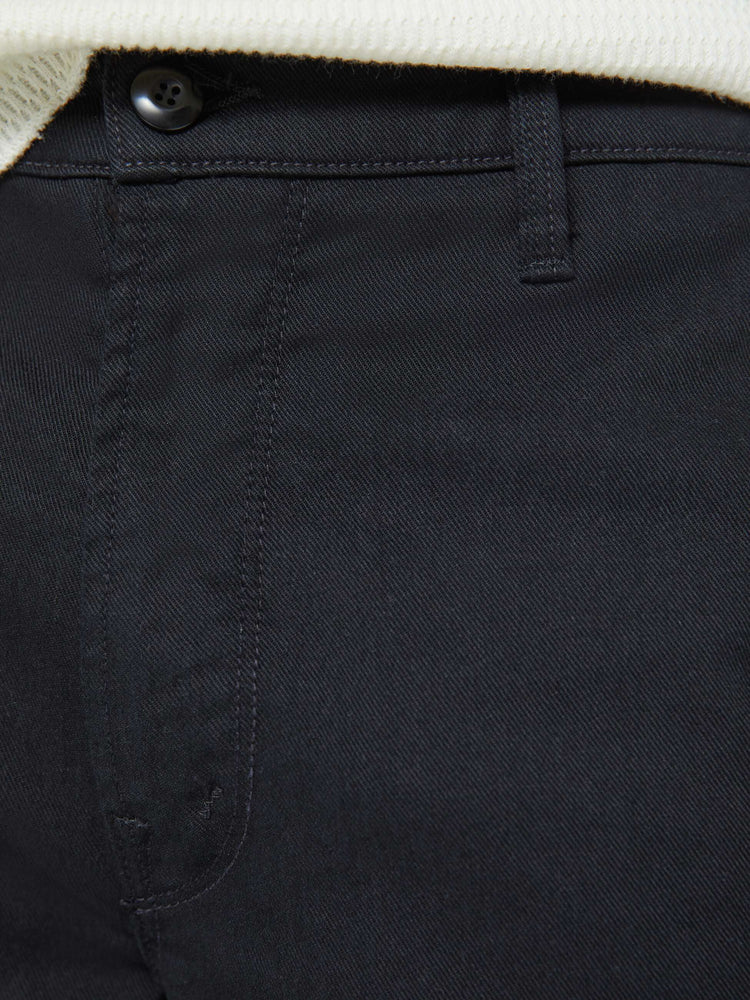 Swatch view of a man in a black pants with a mid rise, slit pockets and a 31-inch inseam with a clean hem.