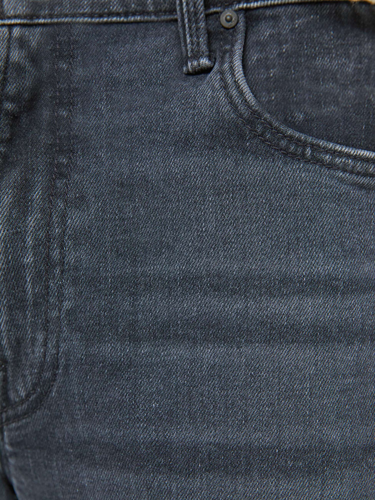 Swatch view of a man in a mid-rise bootcut with a 31-inch inseam and a clean hem in a faded black wash.