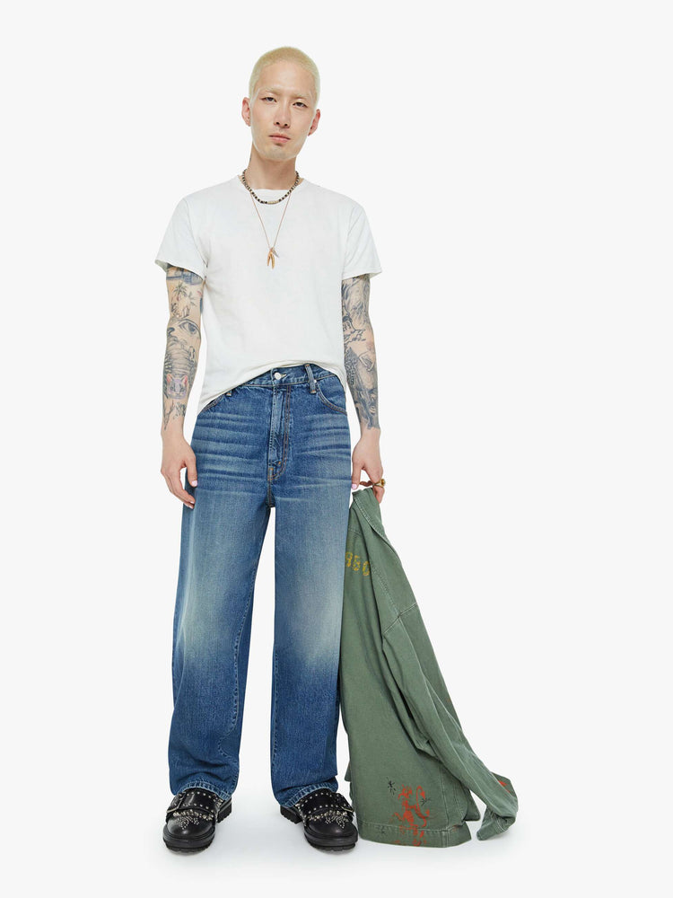 Front view of a men wide straight-leg jean with a high rise, 30-inch inseam, loose fit and a clean hem in mid blue wash.