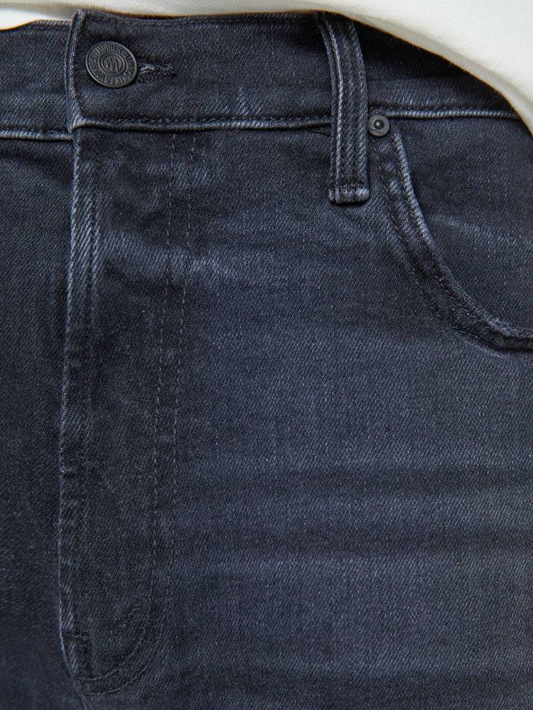 Swatch view of a man in a dark grey straight-leg jean with a mid rise, zipper fly, 30-inch inseam and a clean hem.