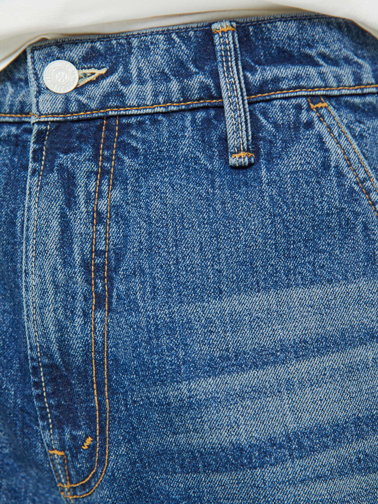 Swatch view of a man in mid-blue wash classic pant with utilitarian pockets, a hammer loop and relaxed leg.