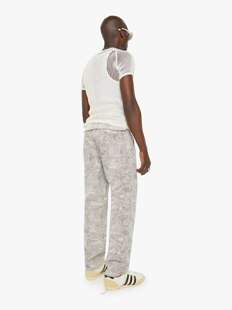 Back view of a mens mid-rise, straight-leg cargo pant with slit pockets, a hammer loop and utility-inspired patches at the knees in a neutral camo print.