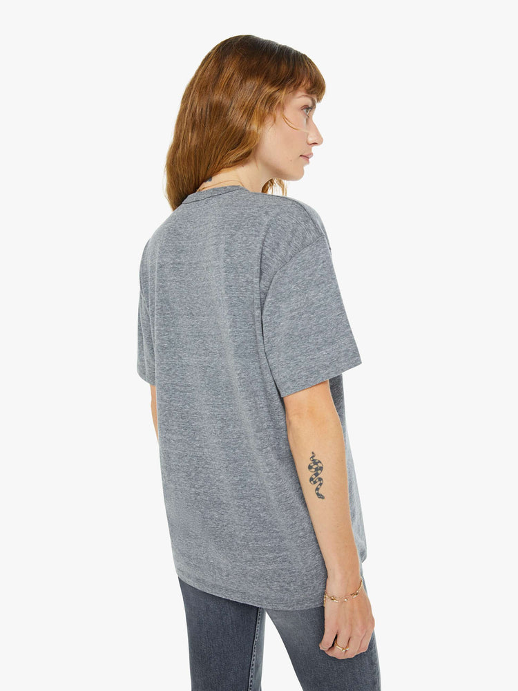 WOMEN back view of a an oversized tee with drop shoulders in a heathered grey with a faded feck of cards with text in green in the front.