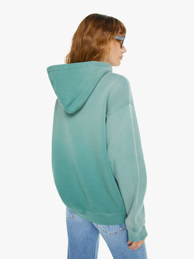 WOMEN back view of an teal oversized hoodie with drop shoulders, ribbed hems and a front patch pocket and colorful text, doodles, and fading at the shoulders.