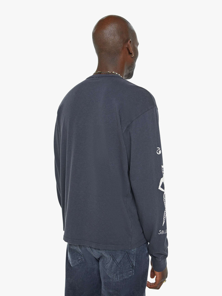 Back view of a man oversized long sleeve tee with drop shoulders and a loose fit in a faded black with an advertisement in white on the front.