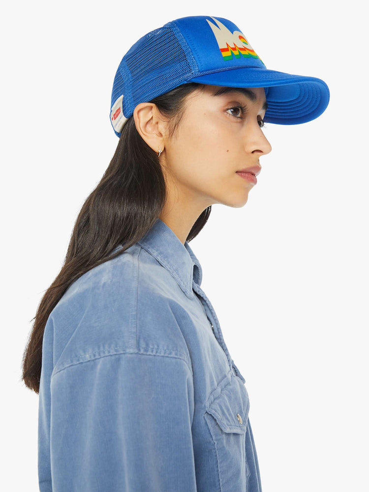 Side view of a vintage-inspired trucker hat designed in blue with MOTHER's name on the front on a model.