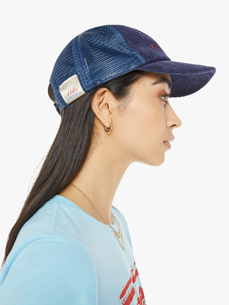 Side view of a vintage-inspired trucker hat designed in dark blue corduroy with MOTHER's name in cursive on the front.