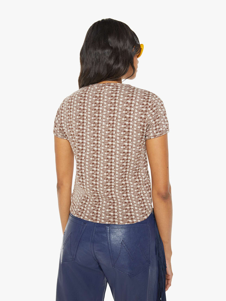 Back view of a woman in cream and brown checkered print with an embroidered cowboy hat tee.