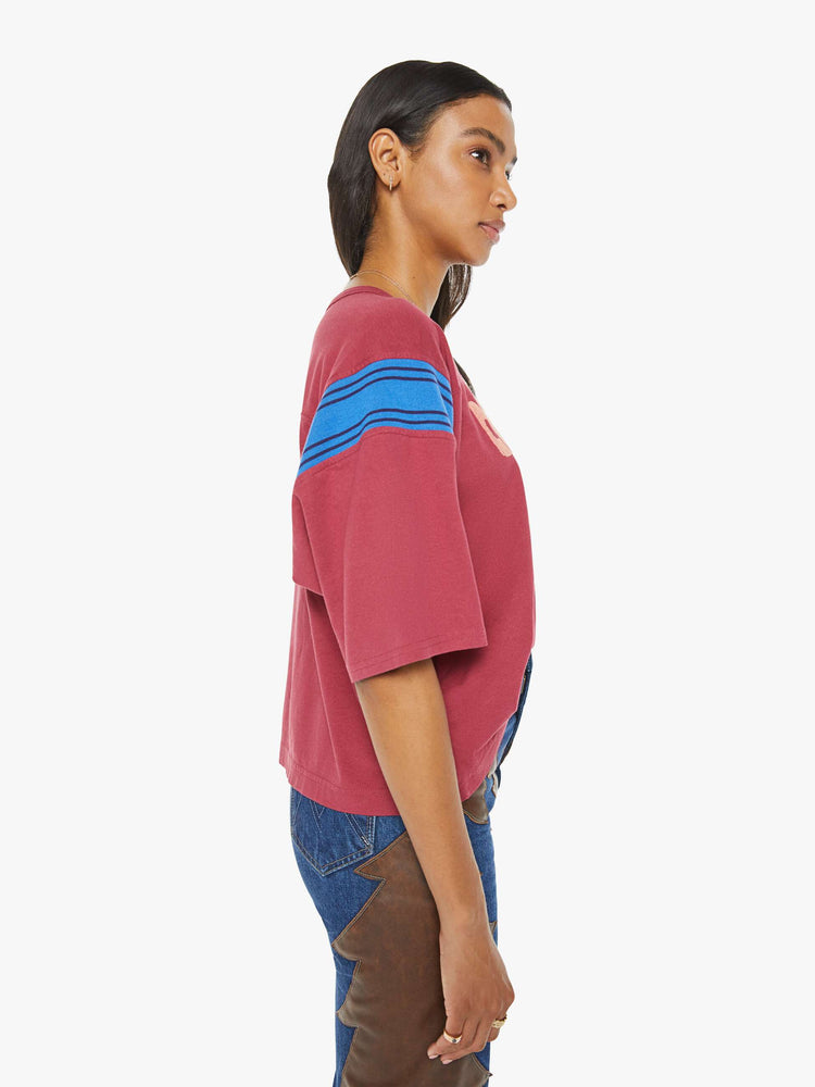 Side view of a faded red vintage-inspired athletic tee with a V-neck, drop shoulders and short boxy sleeves.