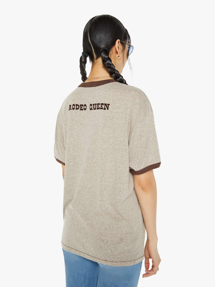 Back view of a woman marled tan oversized tee with drop shoulders and a loose fit with a red heart near the collar.