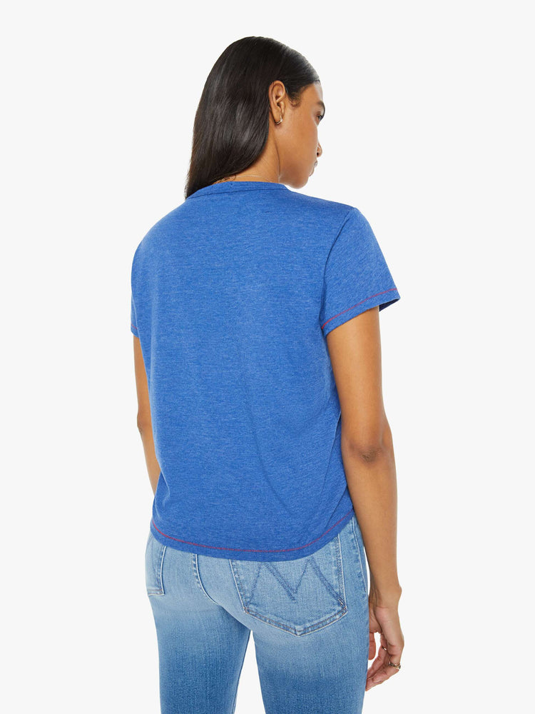 Back view of a woman in a blue tee with mix-matched red patchwork letters on the front that read "Thanks A Lot."