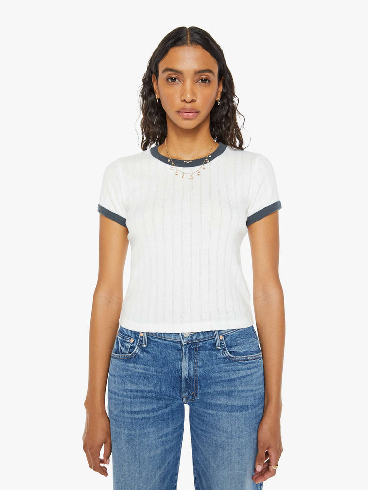 Front view of a women in a white with navy trim shrunken crewneck tee with extra-short sleeves and a cropped hem.