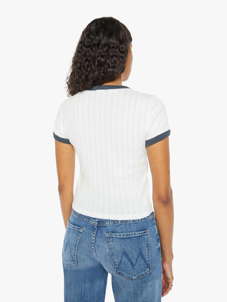 Back view of a women in a white with navy trim shrunken crewneck tee with extra-short sleeves and a cropped hem.