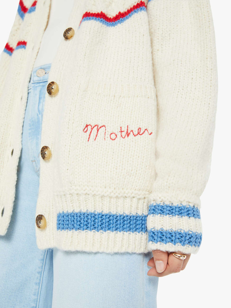 Close up of MOTHERS name embroidered at the hip on a cardigan sweater.