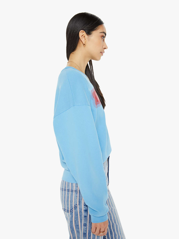 Side view of a woman in crewneck sweatshirt with dropped sleeves in light blue with MOTHER's name in red.