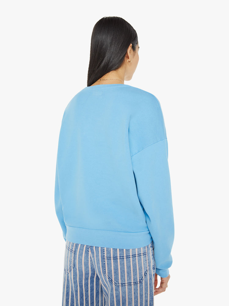 Back view of a woman in crewneck sweatshirt with dropped sleeves in light blue with MOTHER's name in red.