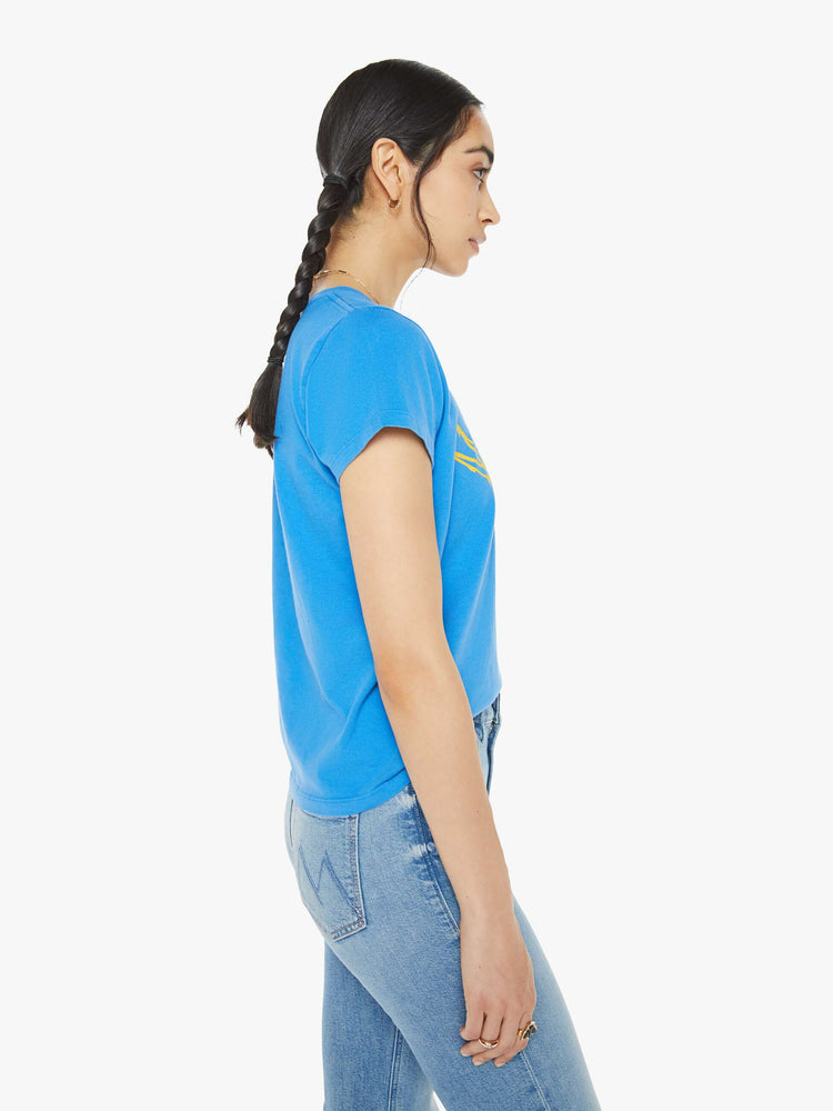 Side view of a woman blue tee with a message from MOTHER and a yellow rose on the front.