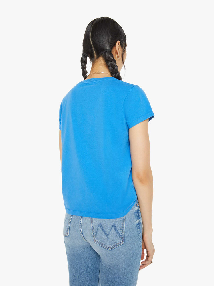 Back view of a woman blue tee with a message from MOTHER and a yellow rose on the front.