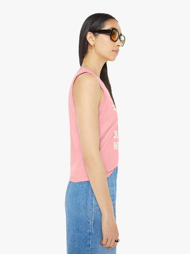 Side view of a woman in a pink cropped muscle tee with a crewneck and boxy fit.