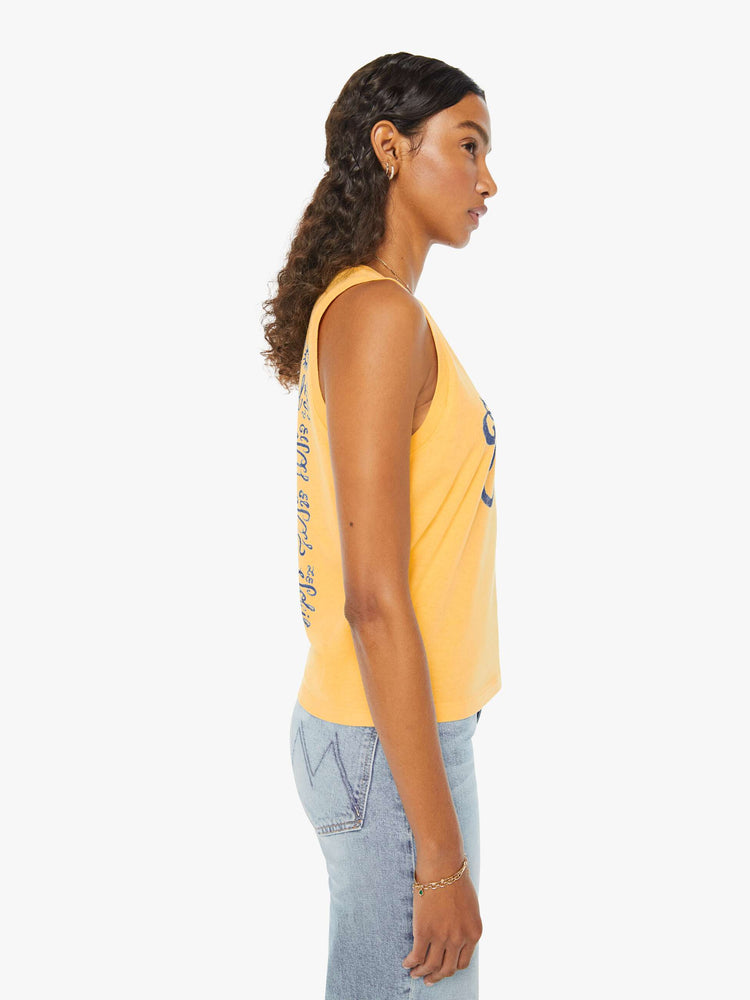 Front view of a woman in a yellow cropped muscle tee that features "El Sol" text in blue.