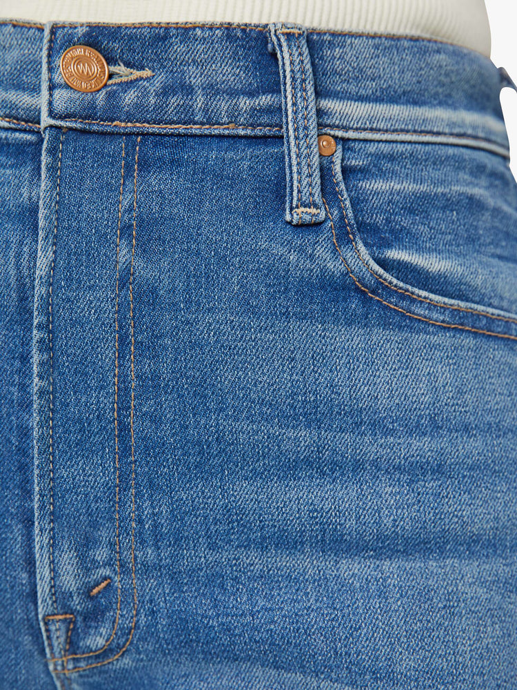 Swatch view of a woman high-waisted skinny-flare jeans with a slightly dropped crotch, long 34-inch inseam, slits at the heels and a clean hem in a mid blue wash.