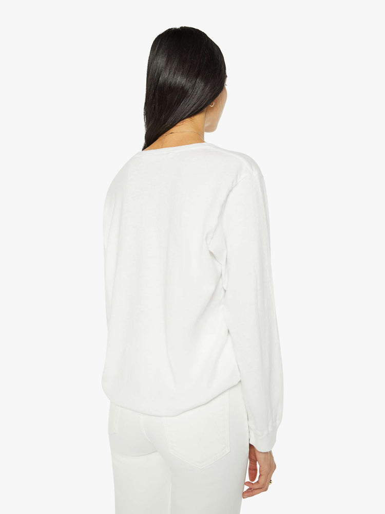 Back  view of a woman crewneck tee with long sleeves and an oversized fit in a bight white hue.