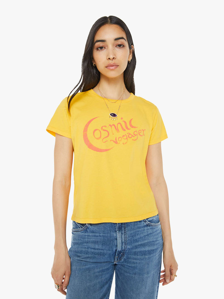 Front view of a woman in a yellow tee with orange graphic on the front.