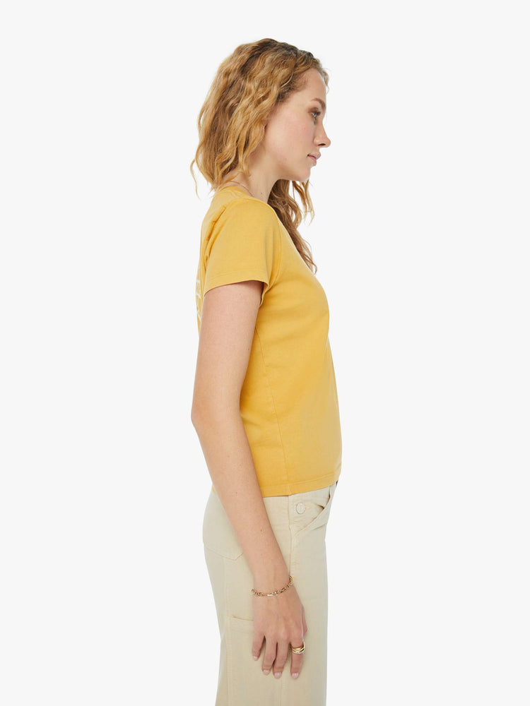 Side view of a woman in a yellow slightly sheer slim fit crewneck with a palm tree graphic and MOTHER's name on the chest and back.