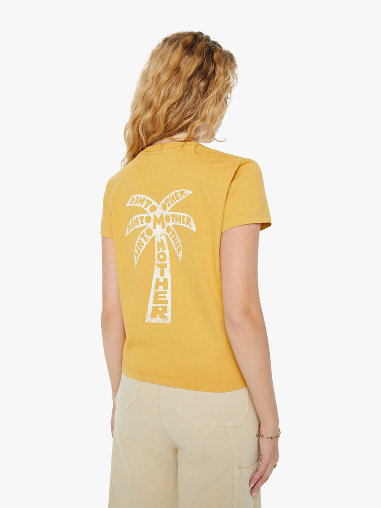 Back view of a woman in a yellow slightly sheer slim fit crewneck with a palm tree graphic and MOTHER's name on the chest and back.