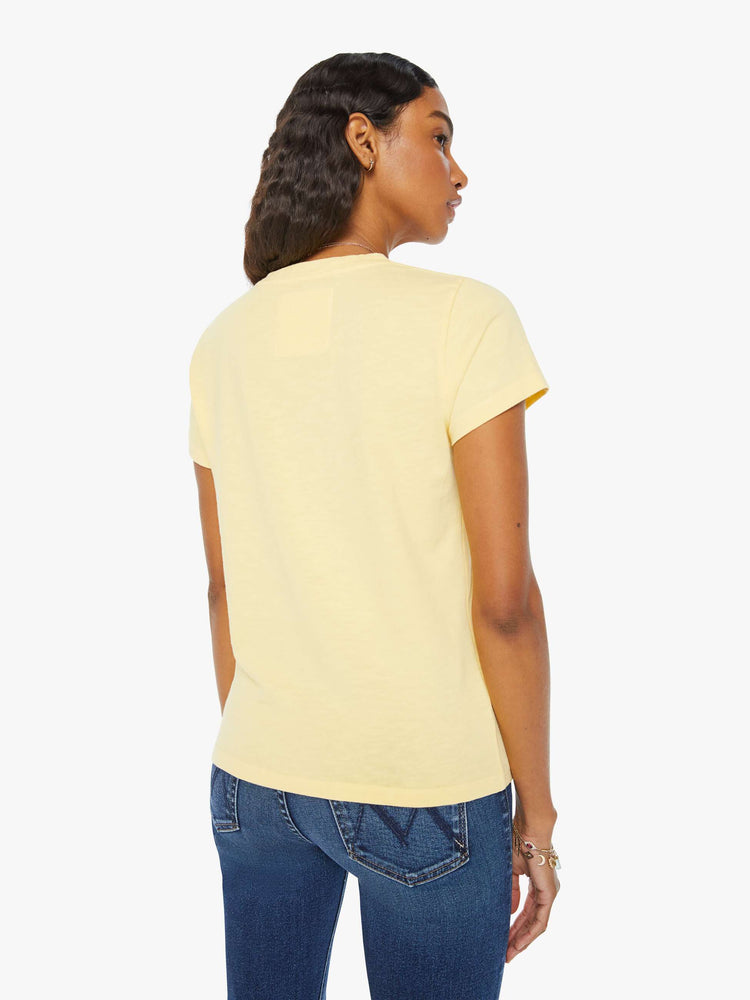 Back view of a woman crewneck with a slim fit in a pastel yellow with a mermaid graphic with text in orange and green on the front.