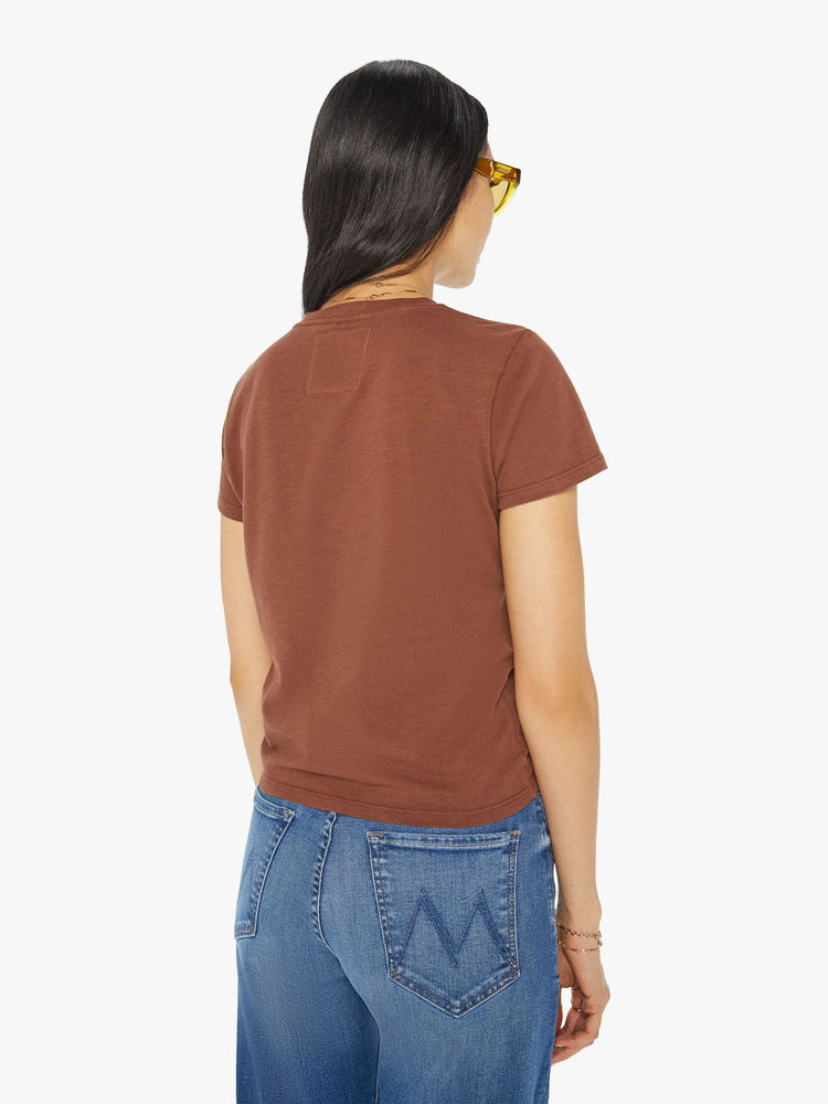 Back view of a woman in a brown crewneck tee with a slim fit featuring a colorful garden bed graphic on the front.