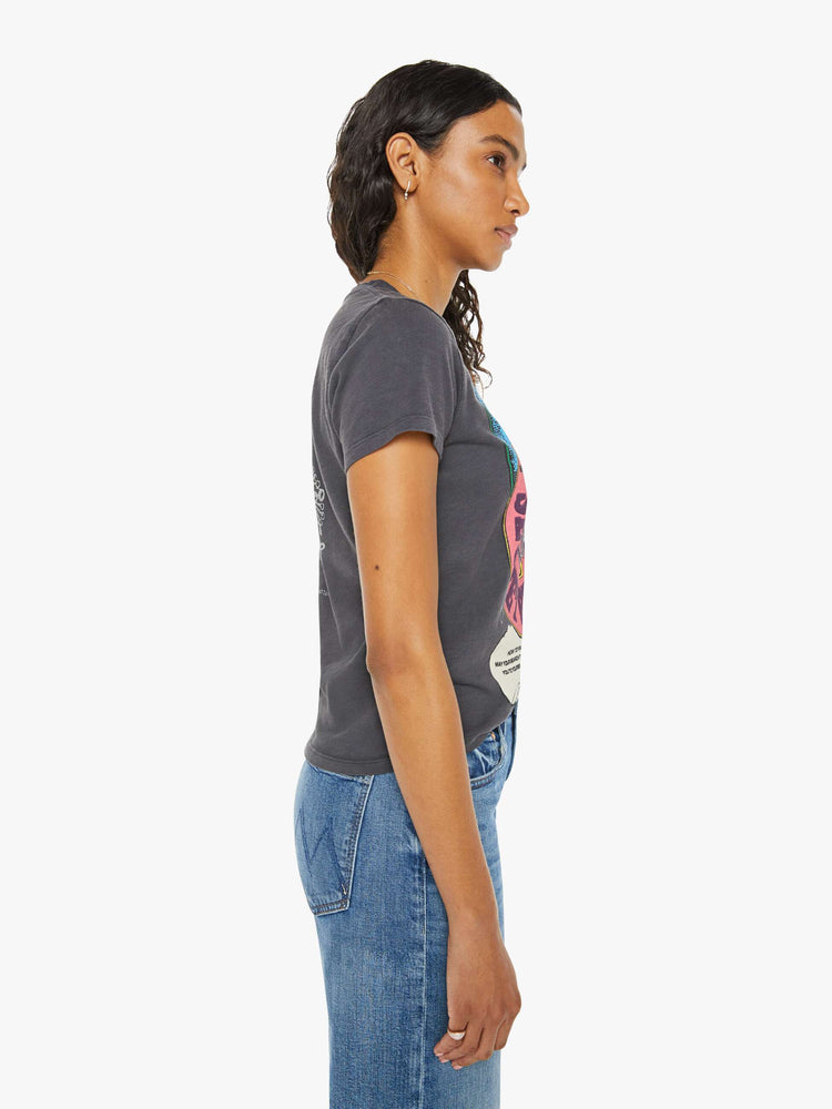 Side view of a woman in faded black tee with colorful graphic on the front and back.