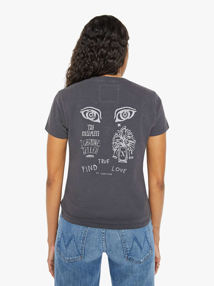 Back view of a woman in faded black tee with colorful graphic on the front and back.