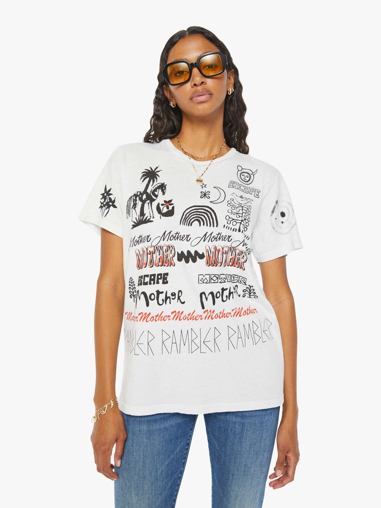 Front view of a woman crewneck tee with an oversized fit and a clean hem with hand drawn doodles in black and orange throughout.