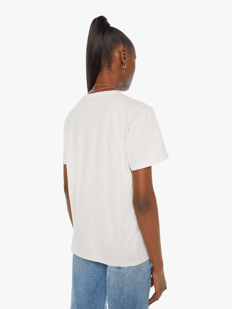 Back view of a woman in a white tee with a colorful mountain graphic and MOTHER's name on the front.