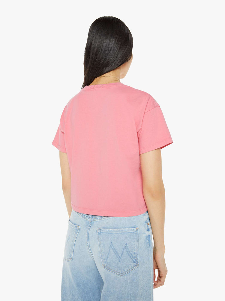 Back view of a pink oversized crewneck tee with drop shoulders, a cropped hem and a boxy fit and purple print.