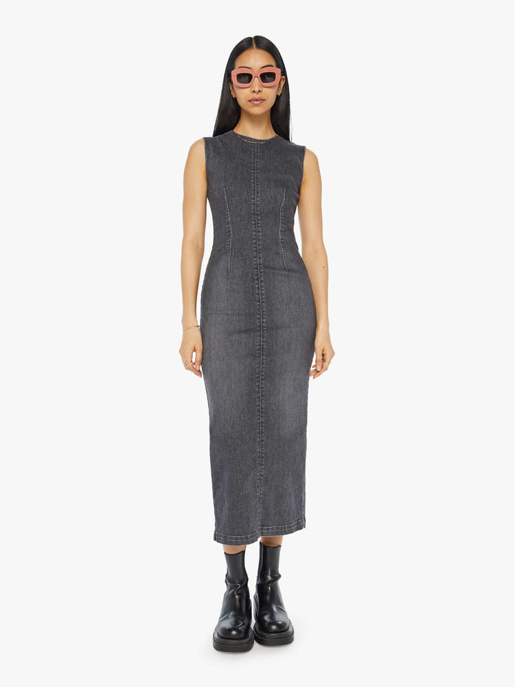 Front view of a woman in a dark grey  sleeveless denim midi dress with a crewneck, seamed details and a narrow fit. 