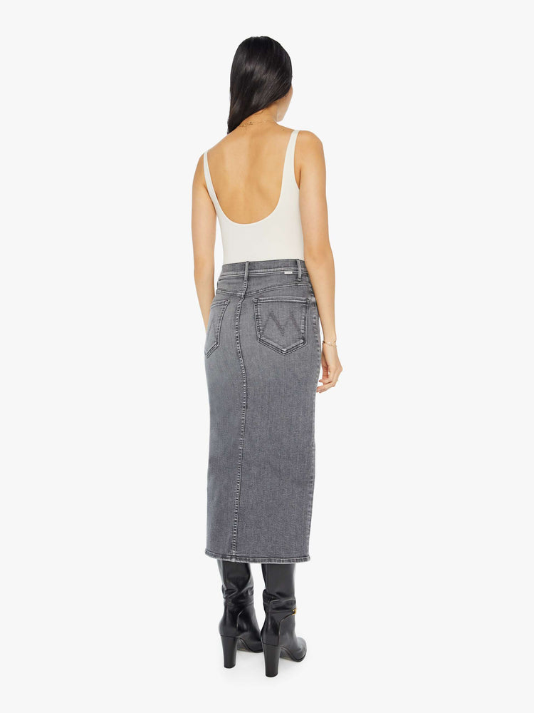 Back view of a grey denim pencil skirt with a high rise, narrow fit and a thigh-high front slit.