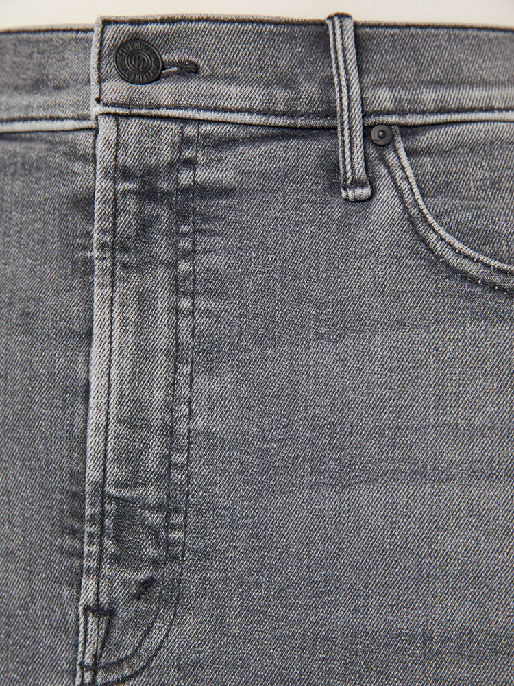 Swatch view of a grey denim pencil skirt with a high rise, narrow fit and a thigh-high front slit.