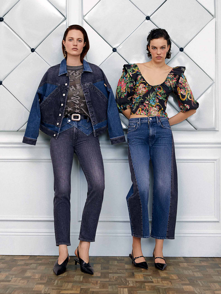 An editorial image of two women leaning against a wall.