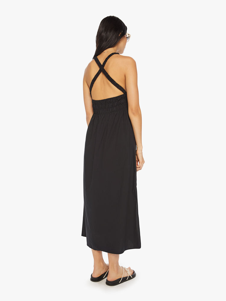 Back view of a woman maxi dress in black, sleeveless dress has a crew neck, thick gathered waistband and an ankle-grazing hem.