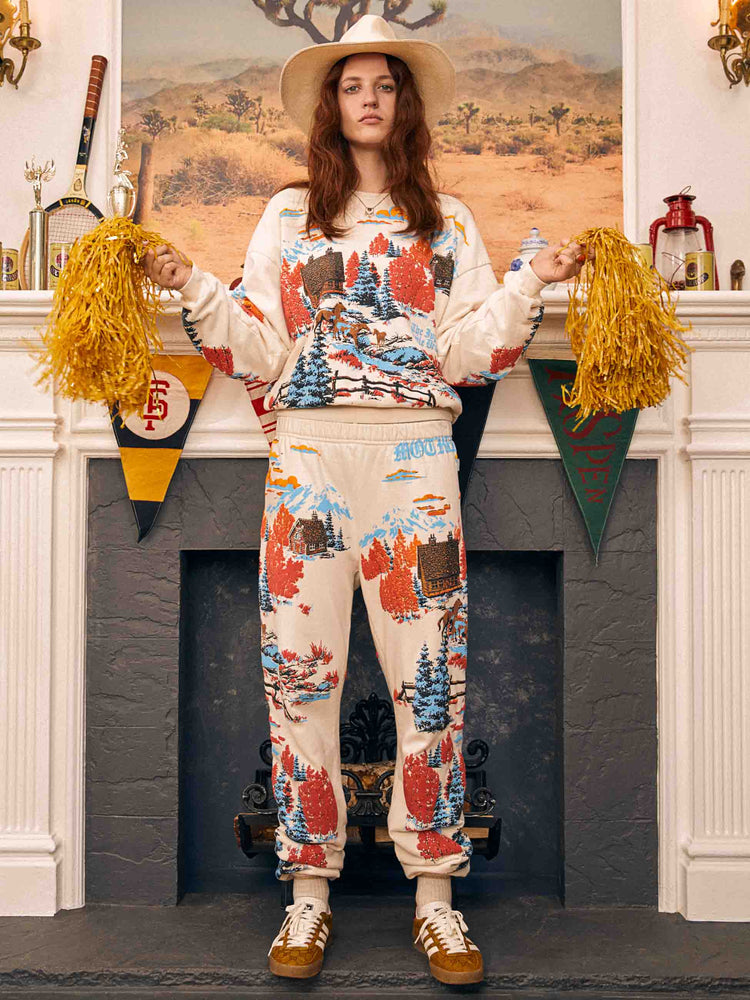 Editorial shot of woman in sweatpants with matching sweathshirt.