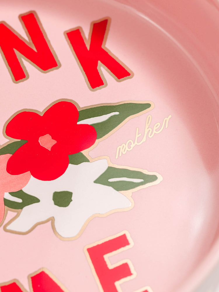 Close up view of a pink ceramic dog bowls with a little encouragement from MOTHER. 