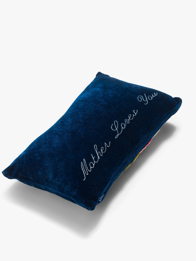 Back view of a cozy, navy blue throw pillow with colorful leaves, flowers and MOTHER's name in pink on the front.