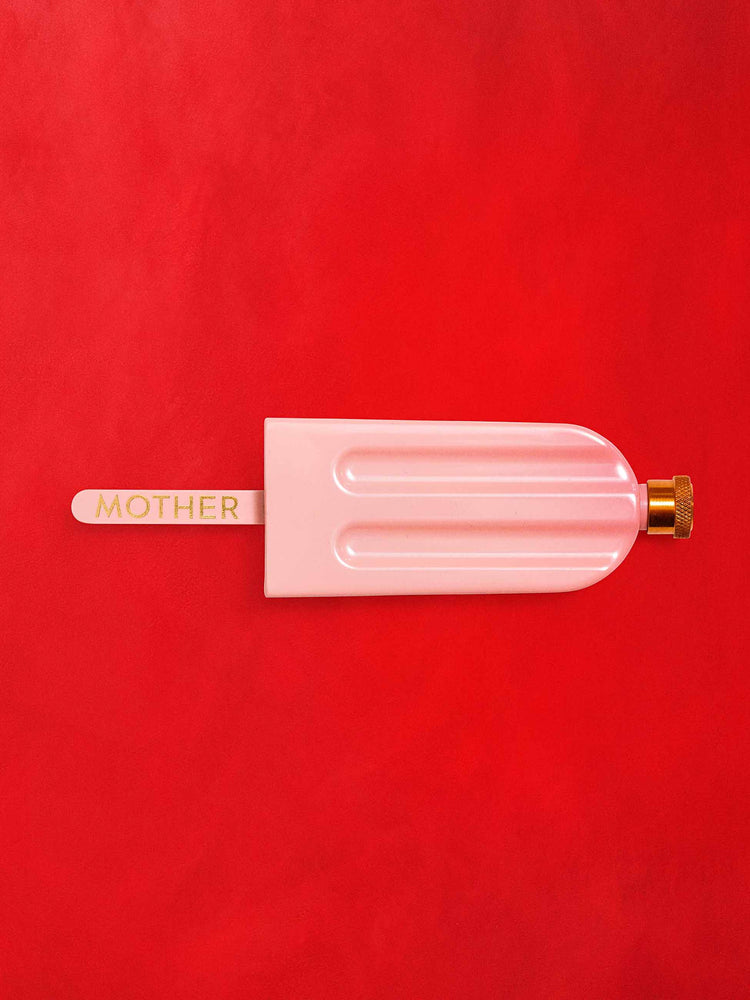 Top view of a pink flask in the shape of a popsicle against a red background.