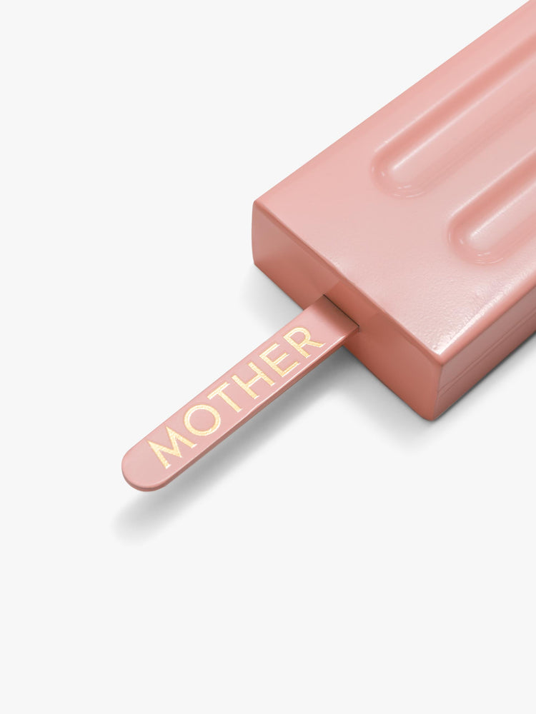 Close up view of a pink popsicle-shaped flask crafted from alloy with a handle and metal screw top.