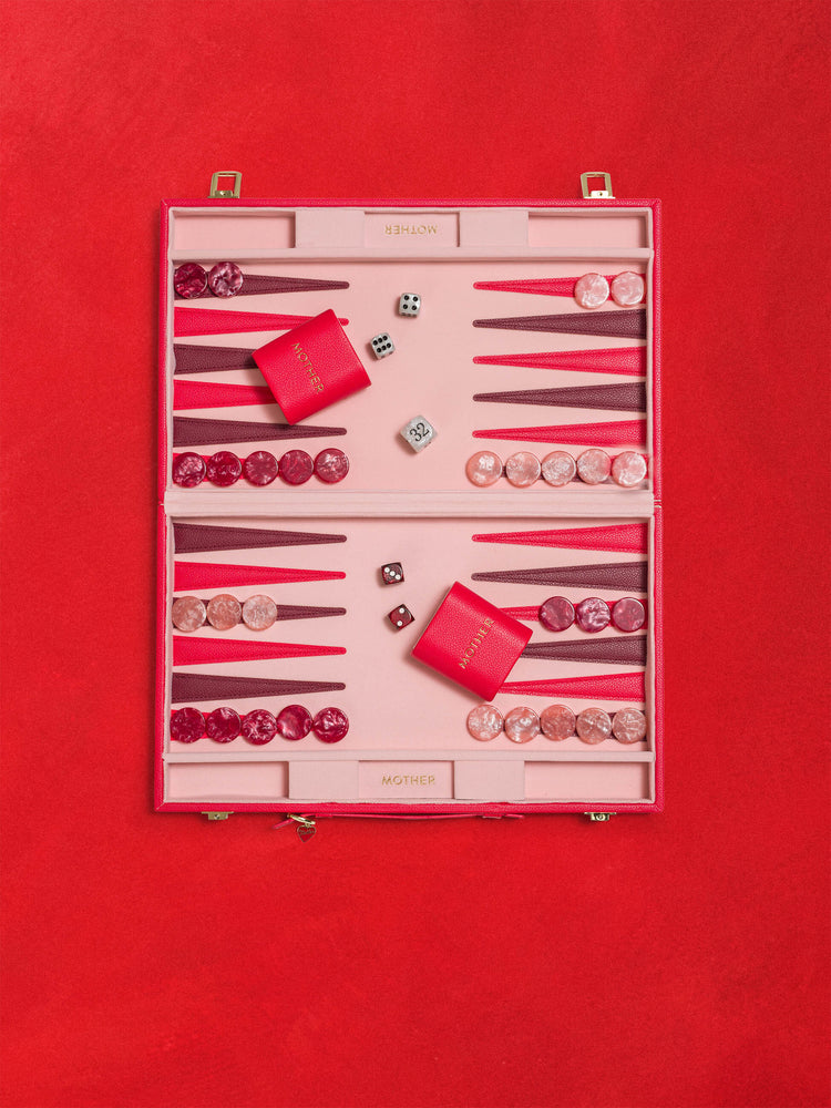 A flat product image of a red and pink backgammon set against a red background.